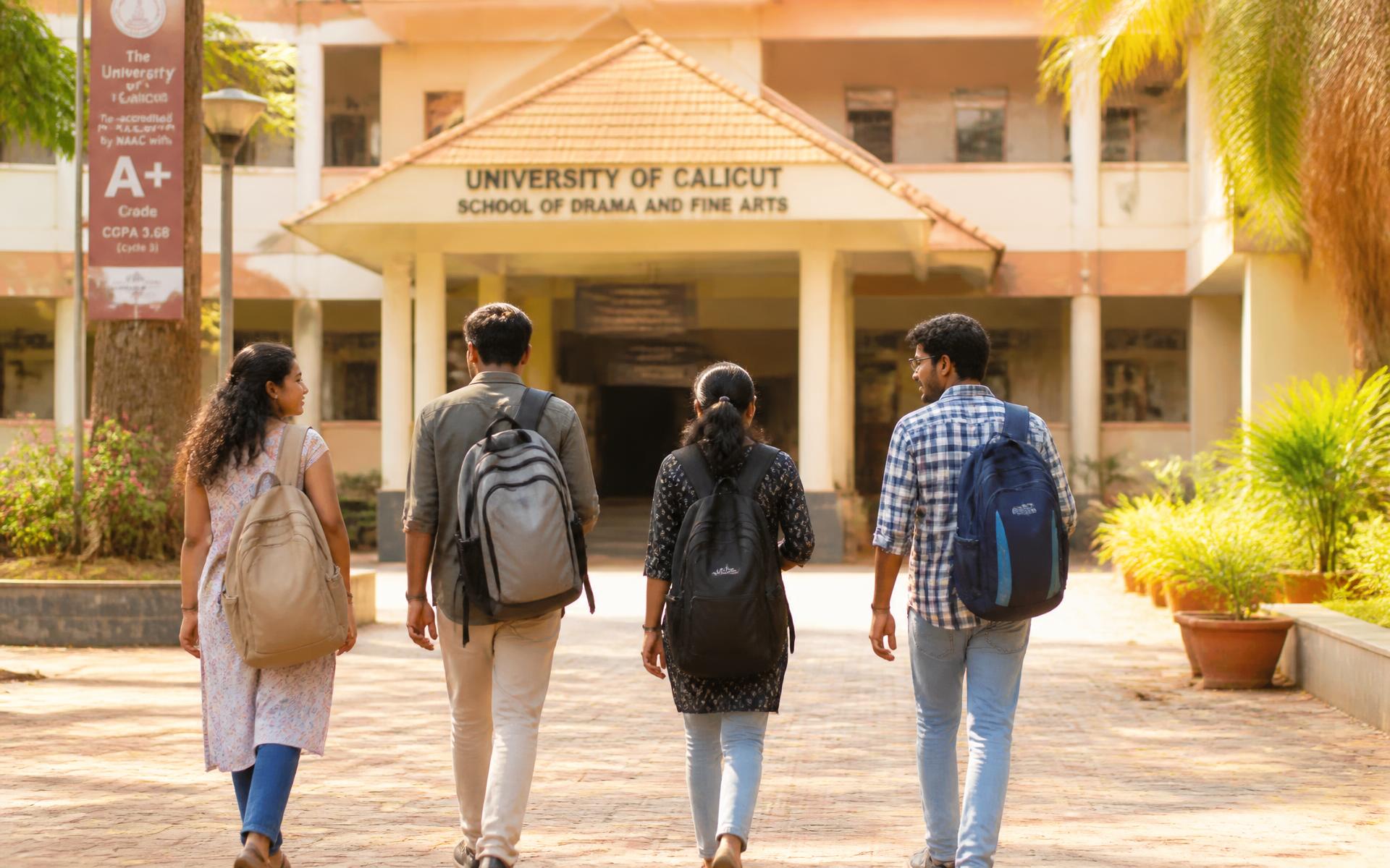 Students walking toward a university building in Kerala